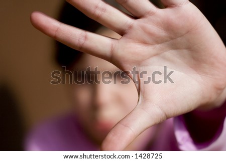 hand in rejecting pose in front of face