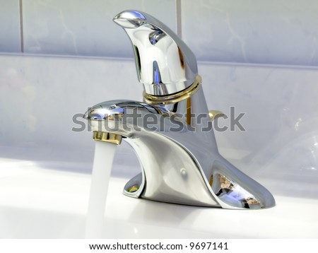 Bathtub faucet on the sink with running water