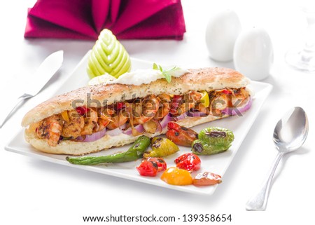 Delicious Grilled Shrimp Sandwich in White Plate over Table