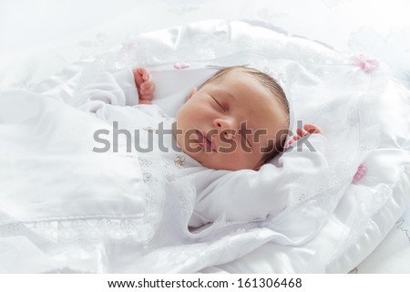 Little Newborn Sleeping over His White Bed