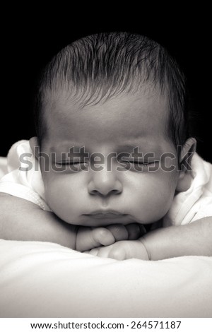 Newborn Baby Boy Sleeping in His Bed Over Black Background