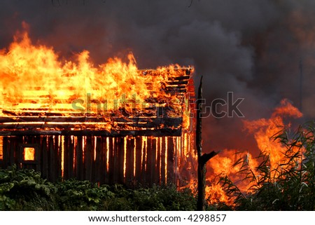 The wooden house on fire