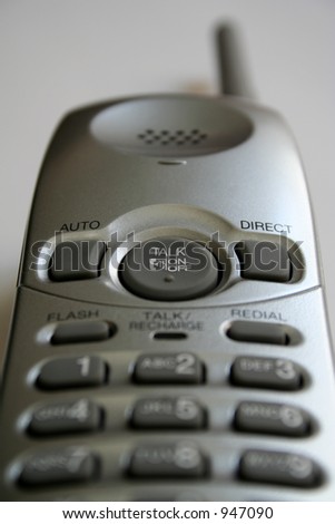 A silver cordless phone. Focus is on the \'TALK\' button.
