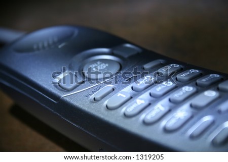 A silver cordless phone.
