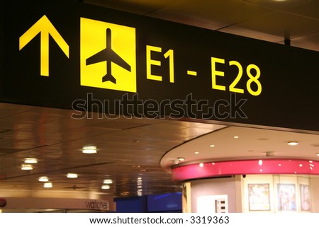 Signboard at the airport showing directions to the boarding gates.