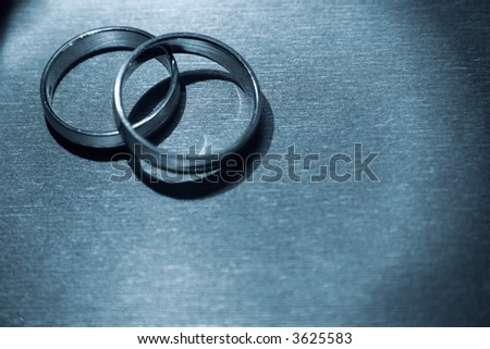 stock photo A pair of wedding bands against a textured background