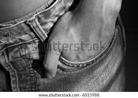 Hand in denim pocket, portraying a casual outlook.