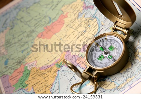 A compass on the world map of the atlas.
