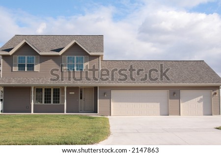 New vinyl sided home with large porch and 3 stall garage
