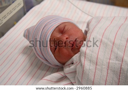 Wrapped newborn in hospital nursery