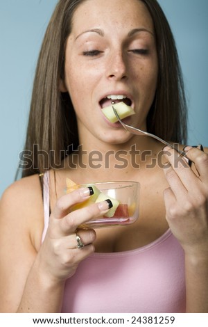 stock photo Model about to bite pineapple with tongue piercing visible