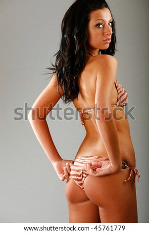 Model pose fixing her bikini bottoms