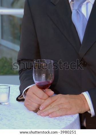 Man with wine glass seated at a table