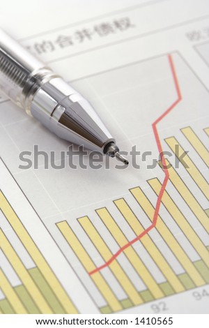 Pen on Positive Earning Graph (focus on the tip of the pen)