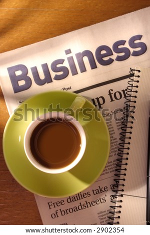 Coffee, Newspaper and Notebook on Desk