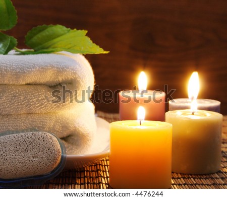 Towel, aromatic candles and other spa objects to make mood relaxing
