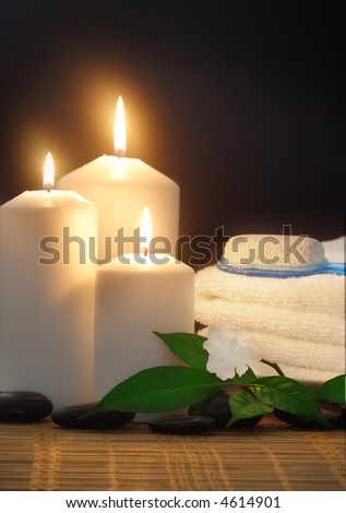 candles,towel and white lilac flower--spa objects to make mood relaxing