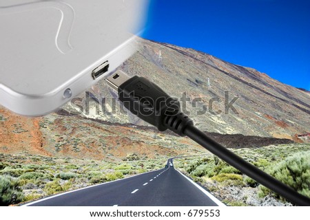 mini usb cable cord and external hard drive over a landscape with a road