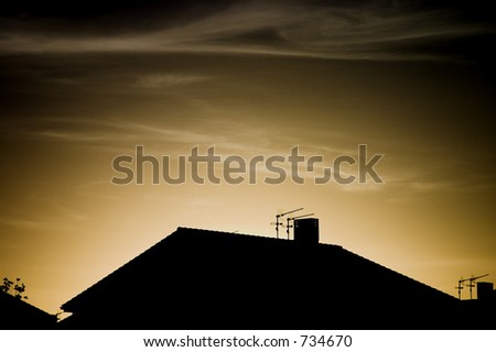 Roof with antennas at the sunset.