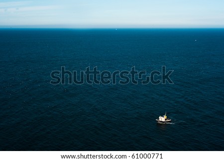 Aerial view of a lonely boat in the ocean