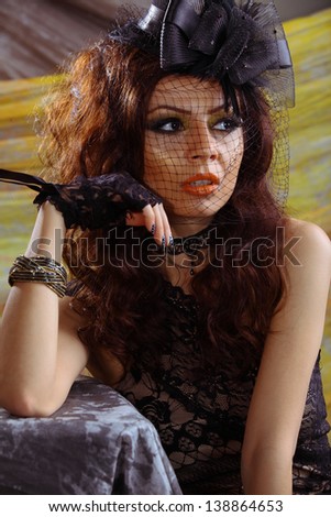 Elegance lady with orange lips and glamour nails, touching face