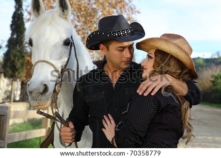 Cowboy and Cowgirl Couple with their White horse