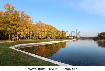 beautiful autumn landscape with trees and ponds, sunny day