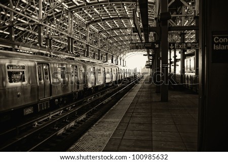 Sepia image of train and platform at the Coney Island subway station
