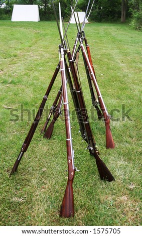 Long antique guns with bayonets from the american civil war period.