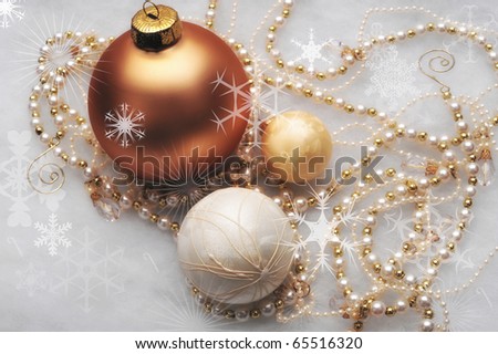 Three gold ornaments with beaded garland surrounding the trio
