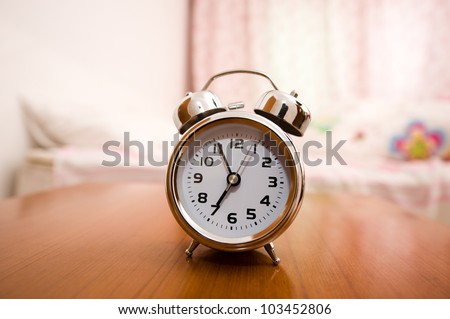 Alarm clock on night table at bed