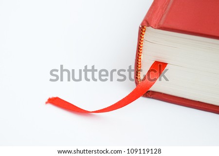 A bookmark in a book helps to find the correct page. Macro with extremely shallow depth of field