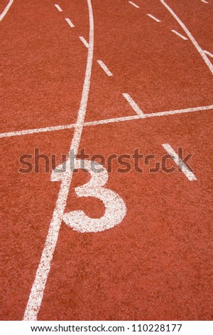 Number three on the start of a running track