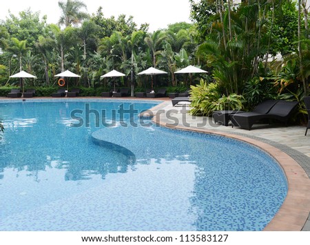 chaise longue and swimming pool in a hotel