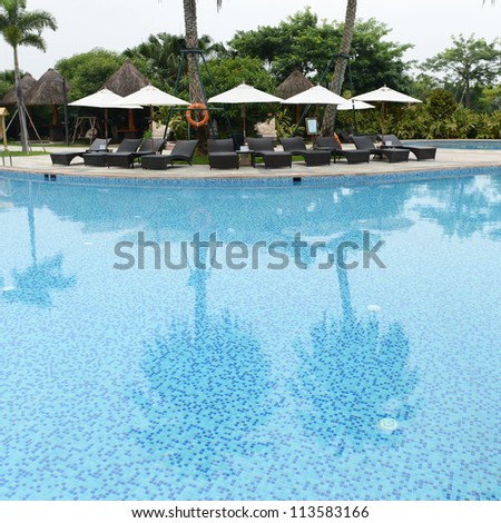 chaise longue and swimming pool in a hotel