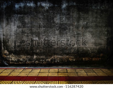 grunge concrete wall with tile floor.