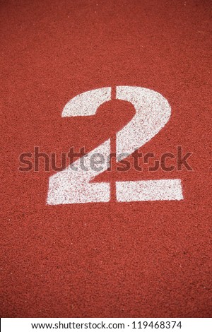Number two on the start of a running track.