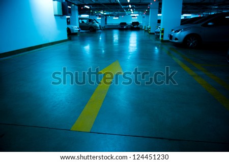 Empty underground parking garage at night