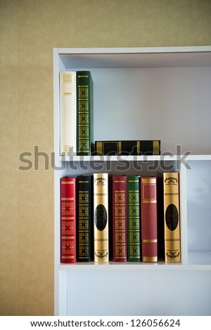 Many old books on the shelf.