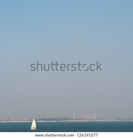 beautiful sailboat sailing with blue water ocean and blue sky background.