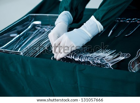 medical instruments with surgeons hand in operation room