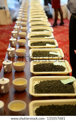 Group of fresh green tea leaves and tea in a row.