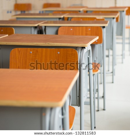 Empty Classroom With Chairs And Desks.