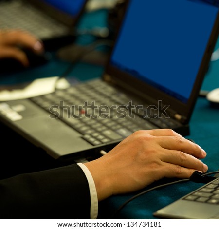 Human hands typing on laptop keyboard.