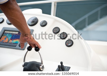 People at the helm of a luxury yacht.