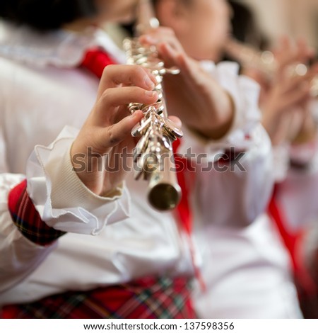 The pupils playing the flute.