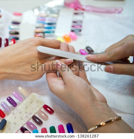 Woman in a beauty salon making nails.