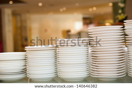 Group of white plates stacked together.