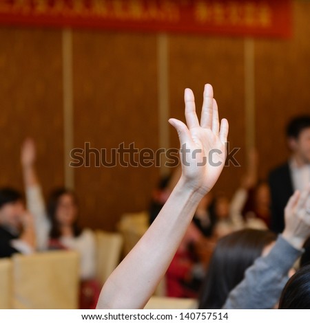 Raised hands in class of university