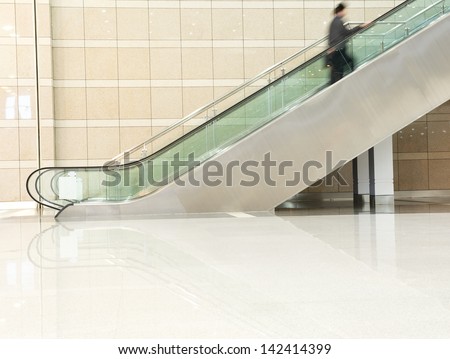 Business People On Escalator. Blurred Motion